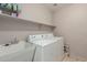 Functional laundry room equipped with a utility sink, shelving, and modern washer and dryer at 3756 E Camden Ave, San Tan Valley, AZ 85140