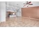 Open living space showcasing tile flooring, ceiling fan, kitchen view, and a neutral color scheme at 3756 E Camden Ave, San Tan Valley, AZ 85140