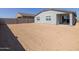 A spacious dirt backyard, ready for landscaping, on a grey home with neutral trim at 3806 N Camden Dr, Florence, AZ 85132