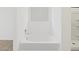Clean white bathroom featuring a bright soaking tub with a window and chrome fixtures at 3806 N Camden Dr, Florence, AZ 85132