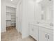Bathroom featuring a double sink vanity and a walk-in closet at 3806 N Camden Dr, Florence, AZ 85132