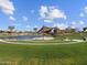 Outdoor stage area with shade and green space, nestled near a pond, adding charm to this vibrant community at 3806 N Camden Dr, Florence, AZ 85132
