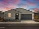Charming single-story home featuring a gray facade, black door, and a two-car garage at 3806 N Camden Dr, Florence, AZ 85132