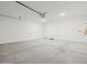 Spacious garage featuring sealed concrete flooring and white walls at 3806 N Camden Dr, Florence, AZ 85132