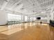 Bright gym featuring stationary bikes, hardwood floors, expansive windows, and high ceilings, perfect for a modern workout at 3806 N Camden Dr, Florence, AZ 85132