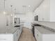 Bright kitchen featuring granite countertops, stainless appliances, and sleek white cabinetry at 3806 N Camden Dr, Florence, AZ 85132