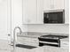 Close up on the Kitchen island with granite counters and a stainless steel faucet at 3806 N Camden Dr, Florence, AZ 85132