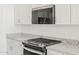 Stainless steel microwave and gas range with granite countertops at 3806 N Camden Dr, Florence, AZ 85132