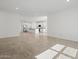 Open floorplan with tile flooring and a view of the kitchen with stainless steel appliances at 3806 N Camden Dr, Florence, AZ 85132