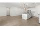 Open-concept living room features modern lighting, tile flooring, and a kitchen island at 3806 N Camden Dr, Florence, AZ 85132