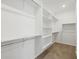 Large walk-in closet features carpet flooring and built-in storage, including shelves and hanging rods at 3806 N Camden Dr, Florence, AZ 85132