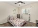 Cozy bedroom featuring a decorative palm tree decal and brightly patterned bedding at 3935 E Blue Spruce Ln, Gilbert, AZ 85298