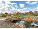 Scenic community park view with stone bridge, lush landscaping, and a gazebo under a bright blue sky at 3935 E Blue Spruce Ln, Gilbert, AZ 85298
