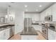 A modern kitchen with stainless steel appliances, granite countertops, and an island, offering ample space at 3935 E Blue Spruce Ln, Gilbert, AZ 85298