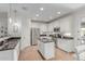 Bright, white kitchen featuring stainless steel appliances, granite countertops, and a functional center island at 3935 E Blue Spruce Ln, Gilbert, AZ 85298