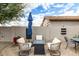 Charming outdoor patio area with comfortable seating and a modern gas fire pit feature at 3935 E Blue Spruce Ln, Gilbert, AZ 85298
