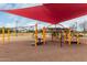 Colorful playground with various climbing and activity features and a shade structure above at 3935 E Blue Spruce Ln, Gilbert, AZ 85298