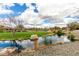 Community pond view with lush green spaces and scenic water features in a tranquil setting at 3935 E Blue Spruce Ln, Gilbert, AZ 85298