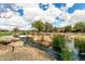 Picturesque community pond view with a tranquil water stream and beautiful neighborhood homes in the distance at 3935 E Blue Spruce Ln, Gilbert, AZ 85298