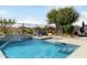 Sparkling pool with water feature, lounge chairs, and landscaped surroundings. Serene backyard oasis at 3935 E Blue Spruce Ln, Gilbert, AZ 85298
