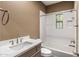 Bathroom featuring a shower-tub combo with white tile and a sink with white countertop and storage at 3935 E Rough Rider Rd # 1368, Phoenix, AZ 85050