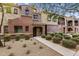Charming townhouse featuring desert landscaping, and a covered entryway at 3935 E Rough Rider Rd # 1368, Phoenix, AZ 85050