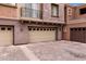 Attached three-car garage showing ample parking and desert landscaping at this elegant home at 3935 E Rough Rider Rd # 1368, Phoenix, AZ 85050