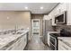 Modern kitchen with granite countertops, stainless steel appliances, and stylish tile flooring at 3935 E Rough Rider Rd # 1368, Phoenix, AZ 85050