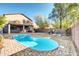 Inviting kidney-shaped pool, set amidst a rock and desert landscaped backyard at 42015 W Hillman Dr, Maricopa, AZ 85138