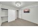 Relaxing bedroom features a ceiling fan, carpet, and a wall-mounted television at 42015 W Hillman Dr, Maricopa, AZ 85138