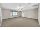 Large bedroom with carpet flooring, a ceiling fan, and window with blinds at 42015 W Hillman Dr, Maricopa, AZ 85138