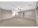 Spacious bedroom with carpet flooring, a ceiling fan, and neutral-toned walls at 42015 W Hillman Dr, Maricopa, AZ 85138
