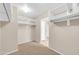 Walk-in closet with carpet flooring and white shelving on all sides at 42015 W Hillman Dr, Maricopa, AZ 85138