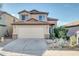 Charming two-story home with a well-manicured front yard and a two-car garage at 42015 W Hillman Dr, Maricopa, AZ 85138