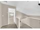 The upstairs hallway leads to the bedrooms and bathrooms, creating a bright and airy feel at 42015 W Hillman Dr, Maricopa, AZ 85138