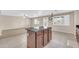 Open concept kitchen with a large island, tiled flooring, and a neutral color palette at 42015 W Hillman Dr, Maricopa, AZ 85138