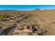 Expansive aerial view of a desert home featuring a private pool, solar panels, and mountain views at 42943 N Livingstone Way, Anthem, AZ 85086