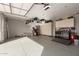 Spacious garage with epoxy flooring, overhead storage, and built-in cabinets for tools and equipment at 42943 N Livingstone Way, Anthem, AZ 85086