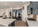 Well-lit kitchen features stainless steel appliances, blue cabinets, a gas range, and quartz countertops at 42943 N Livingstone Way, Anthem, AZ 85086