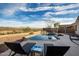 Relaxing backyard retreat featuring a private pool with rock accents and comfortable lounge chairs at 42943 N Livingstone Way, Anthem, AZ 85086