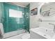 Bathroom with modern vanity, commode, and green tiled shower and tub combination at 4308 E Montecito Ave, Phoenix, AZ 85018