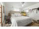 Bedroom with white bedding, a ceiling fan, and a sliding-door closet at 4308 E Montecito Ave, Phoenix, AZ 85018