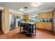 Bright kitchen features stainless appliances, green countertops, and a cozy center island with seating at 4308 E Montecito Ave, Phoenix, AZ 85018