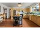 Bright kitchen with stainless steel appliances, island with seating, tile flooring, and lots of storage at 4308 E Montecito Ave, Phoenix, AZ 85018