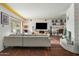 Stylish living room featuring a large sectional, modern entertainment center, and a cozy fireplace for relaxation at 4308 E Montecito Ave, Phoenix, AZ 85018