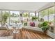 Light-filled sunroom boasts white dining set, bench seating, views of the pool and tropical landscaping at 4308 E Montecito Ave, Phoenix, AZ 85018