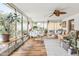 Bright sunroom featuring a dining area with white chairs, wood floors, and ample natural light at 4308 E Montecito Ave, Phoenix, AZ 85018