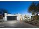 Stunning exterior elevation features a large driveway and black garage doors at 4731 E Monte Vista Rd, Phoenix, AZ 85008