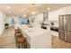 Modern kitchen with sleek white cabinets, stainless steel appliances, and a large island with seating at 4731 E Monte Vista Rd, Phoenix, AZ 85008