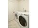 Bright laundry room with tile flooring, updated washer and dryer, and white paint at 4731 E Monte Vista Rd, Phoenix, AZ 85008